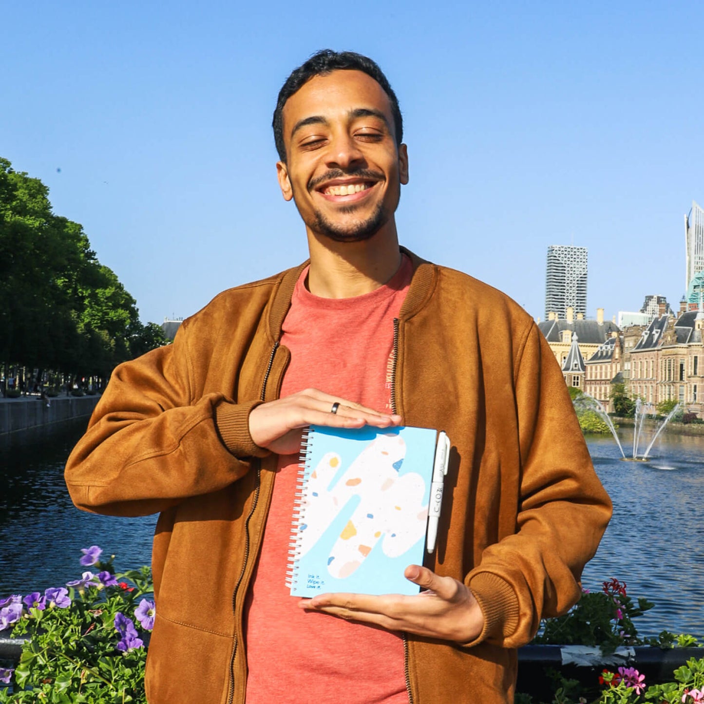 Guy holding Rocky Ice A5 erasable notebook