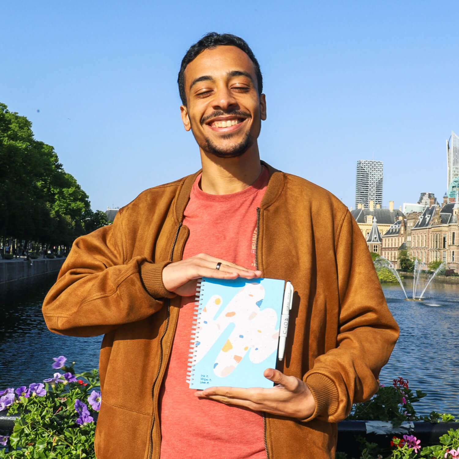 Guy holding Rocky Ice A5 erasable notebook
