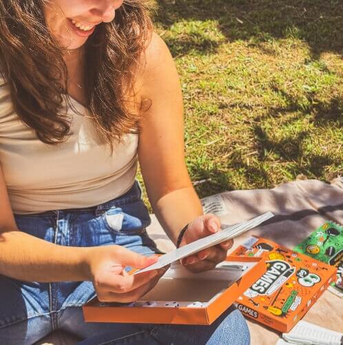 Girl holding erasable pen-on-paper games