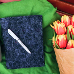 moyu-pen-on-a-blue-sustainable-sleeve-for-notebooks