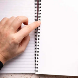 person-clicking-in-a-divider-tab-into-an-a5-notebook