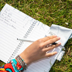 person-wiping-erasable-notebook-with-moyu-cloth