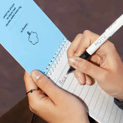 person-writing-on-an-erasable-notepad