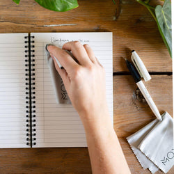someone-erasing-a-vintage-design-stone-paper-notebook