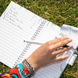 someone-wiping-an-erasable-stone-paper-notebook