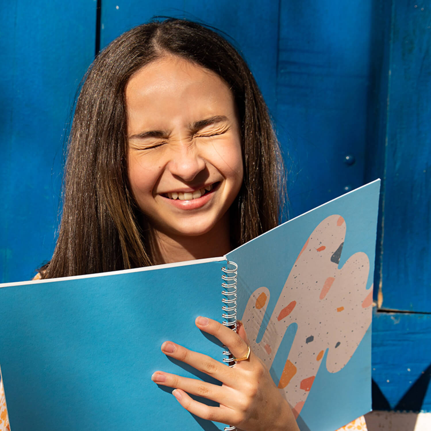Student holding erasable Rocky Ice notebook