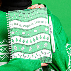 girl-holding-ugly-christmas-sweater-notebook