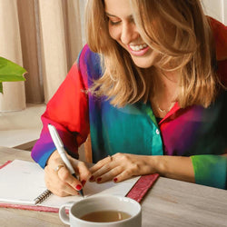 girl writing with erasable ballpoint pen in notebook