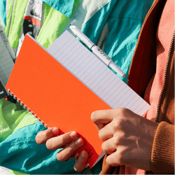 guy-opening-sunset-orange-erasable-notebook