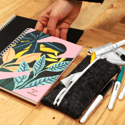 recycled-felt-pencil-case-next-to-black-notebook