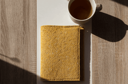 yellow-notebook-sleeve-during-sunrise